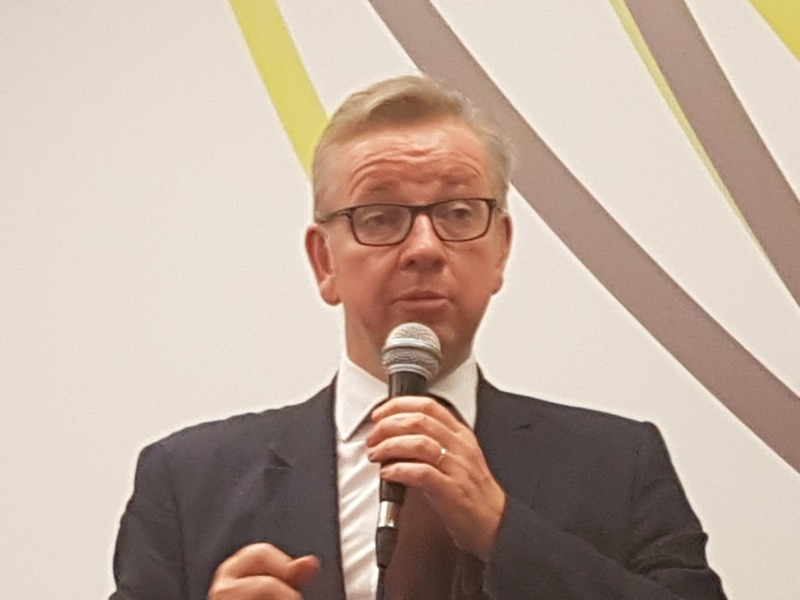 Michael Gove speaking into a microphone at a dinner, 2016